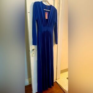 Blue long sleeve dress, with shoulder pads. Slits on both sides.